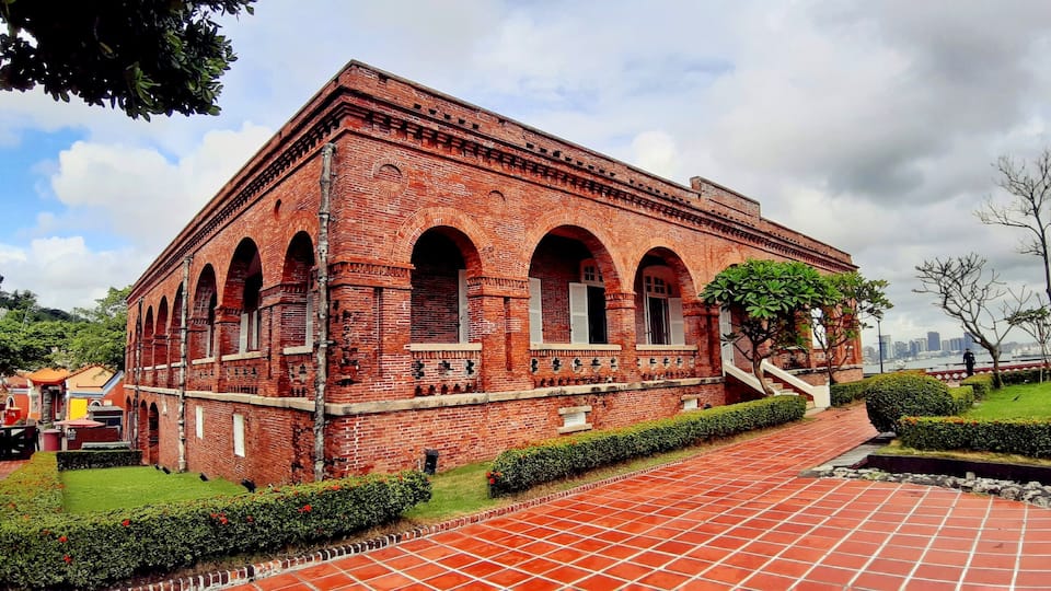 The British Consular Residence at Takow was built on the hill of Shaochuantou. This stand-alone red-brick building with wooden veranda was used as a venue for receiving diplomatic envoys and guests, as well as being the consul's residence. In 1900, it was reconstructed with an arched veranda. During the Japanese colonial period, it was converted into the Kaohsiung Marine Observatory. In the early period after the National Government took over Taiwan, it was converted again as a meteorological observatory. In 1977, Typhoon Thelma devastated the building. In 1985, a restoration project was initiated. In 1987, it was publicly proclaimed a historic site. In 2004, the Bureau of Cultural Affairs repurposed and reutilized this historic site, and it became a famous cultural tourist attraction in Kaohsiung City.