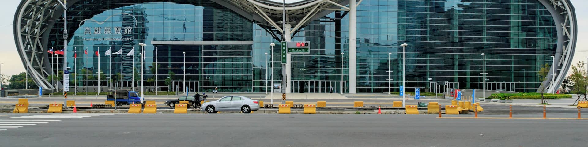 A modern architectural building with a curved design and reflective glass facade.