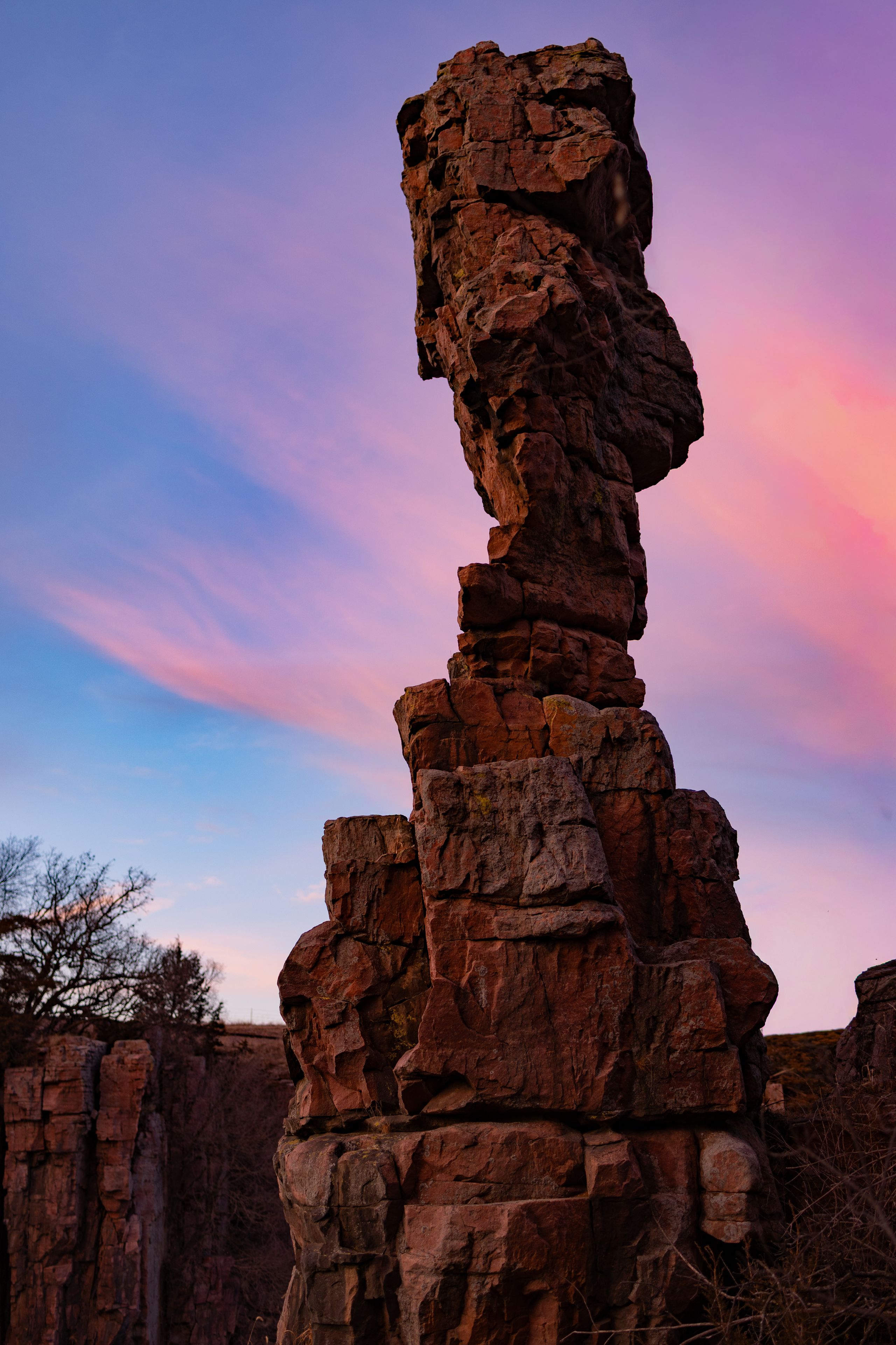 Balanced quartzite rock formation at Palisades State Park under a sunset sky.