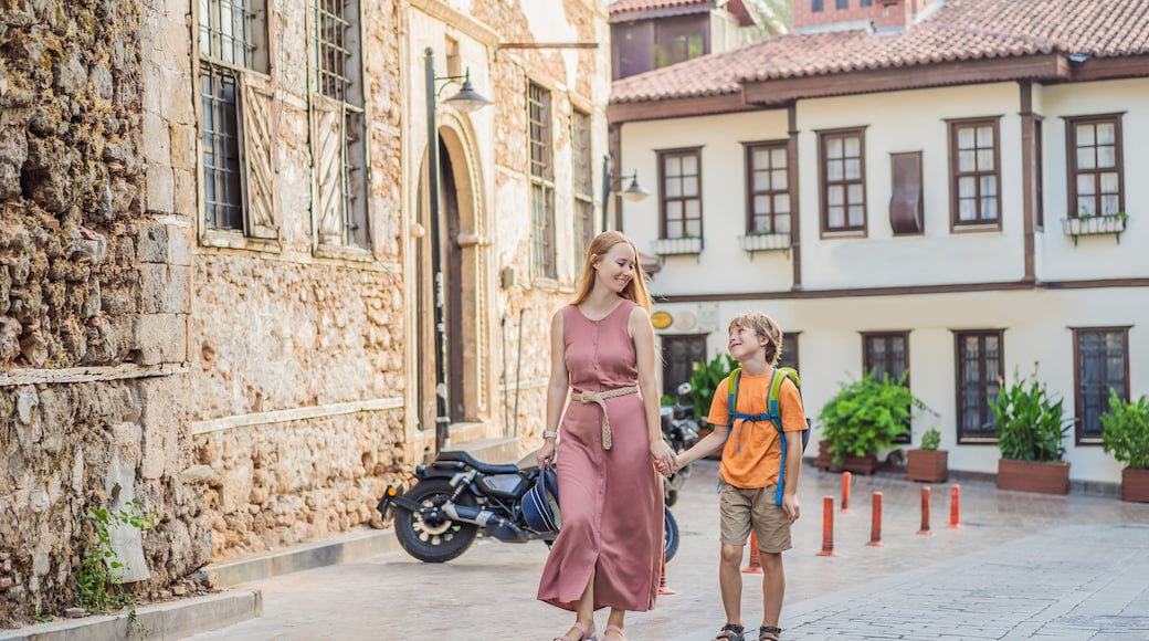 Mom and son tourists in Old town Kaleici in Antalya. Turkiye. Panoramic view of Antalya Old Town port, Taurus mountains and Mediterrranean Sea, Turkey. Traveling with kids concept