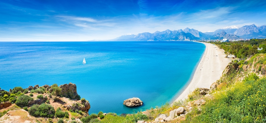 Panoramic aerial view of beautiful blue gulf and long Konyaalti beach in Antalya, Turkey.