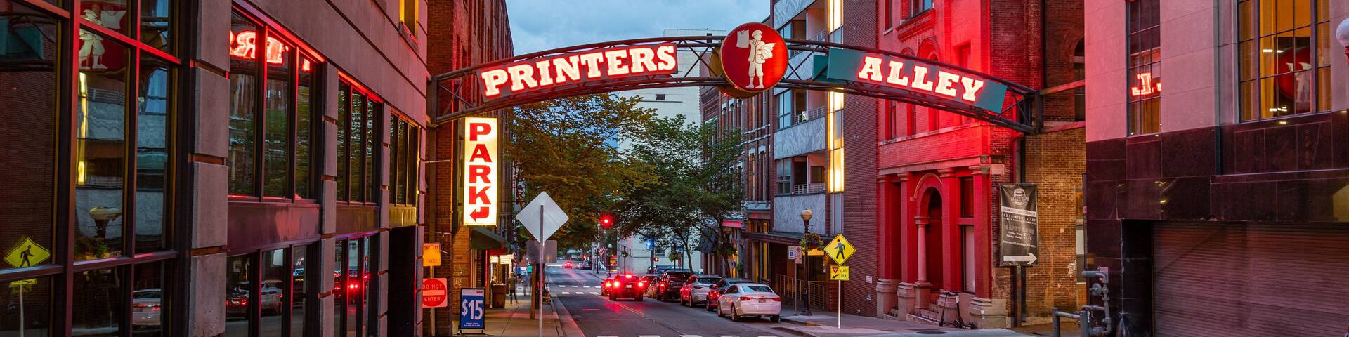 Printer\'s Alley which includes night scenes and signage