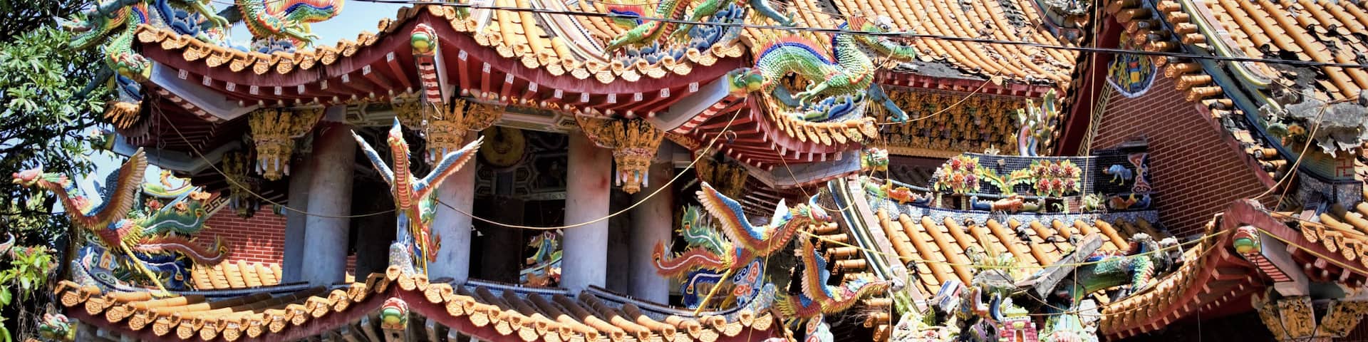 A traditional Chinese temple with ornate roofs and dragon decorations.