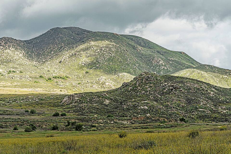 A mountainous landscape with rocky terrain and sparse vegetation.