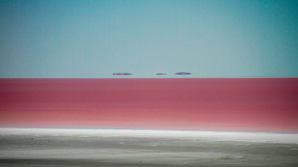A flat landscape with a red and white horizontal stripe.