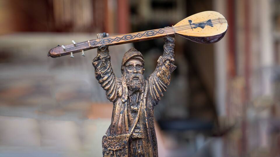 A statue of a figure holding a lute.