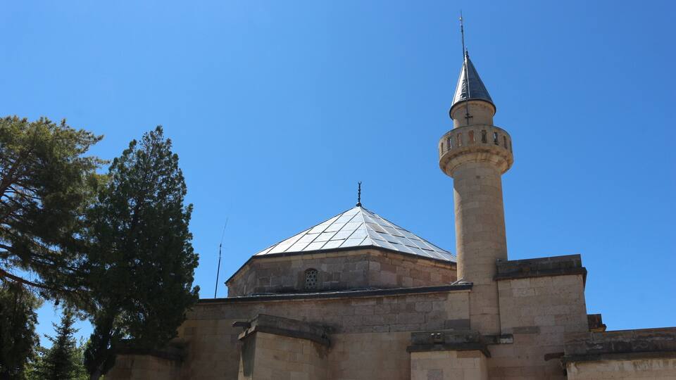 A historic building with a prominent minaret and dome.
