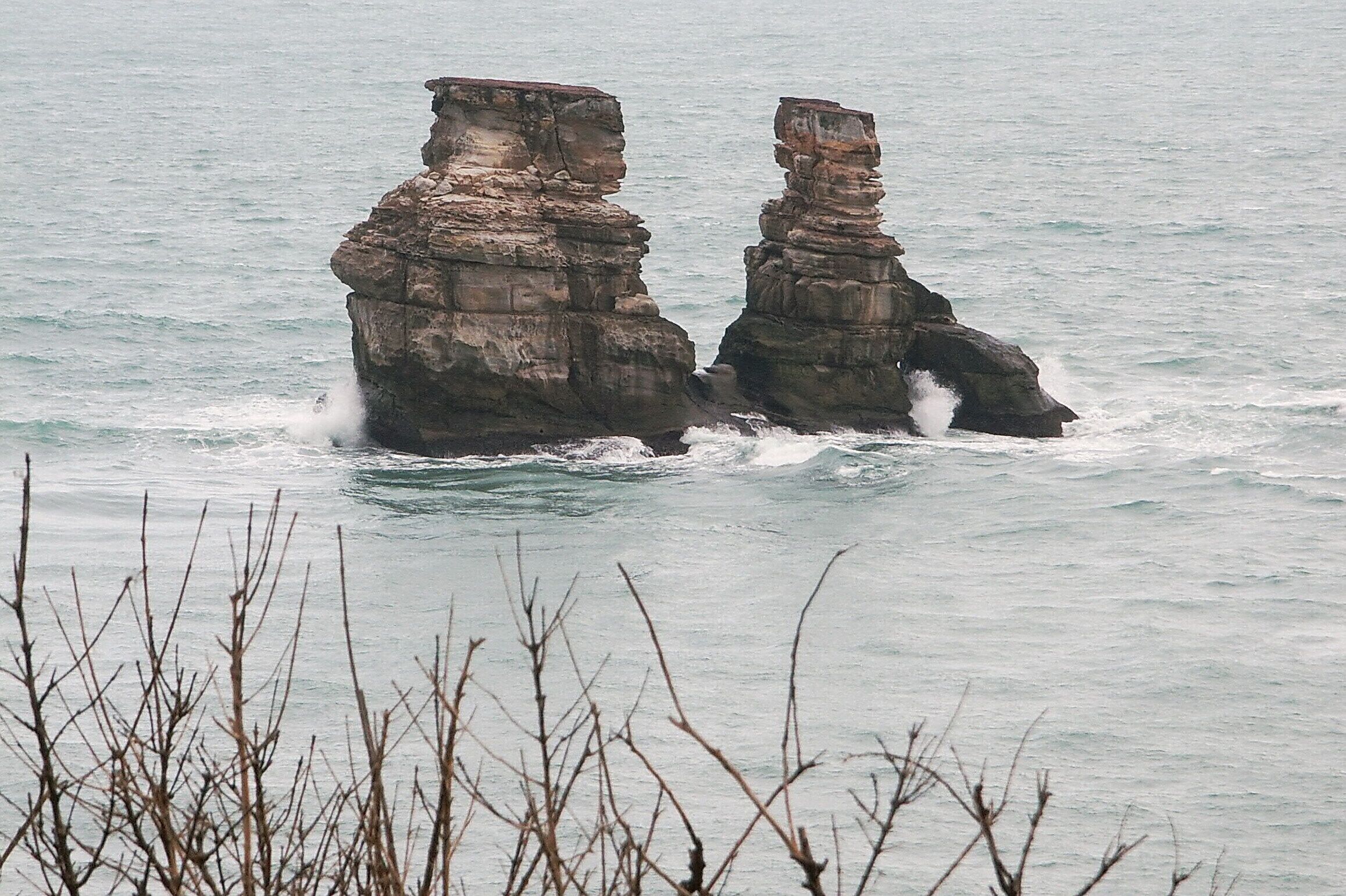 Two rock formations in the ocean.