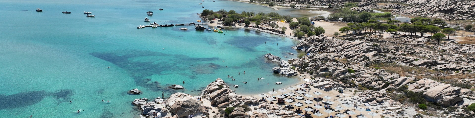 Aerial drone photo of famous small organised beach with unique rock formations of Kolimbithres or Kolympithres in the gulf of Naousa, Paros island, Cyclades, Greece