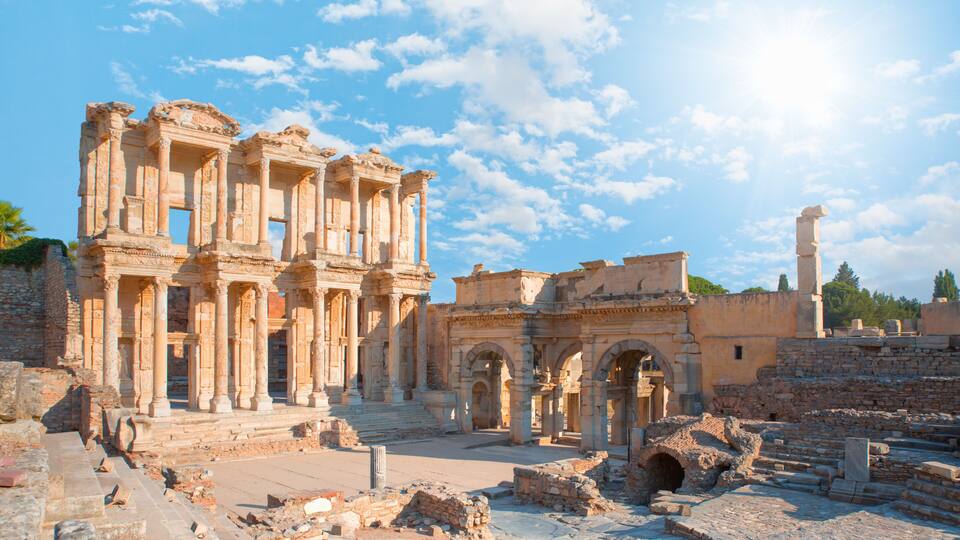 Ancient ruins with columns and arches under a clear sky.