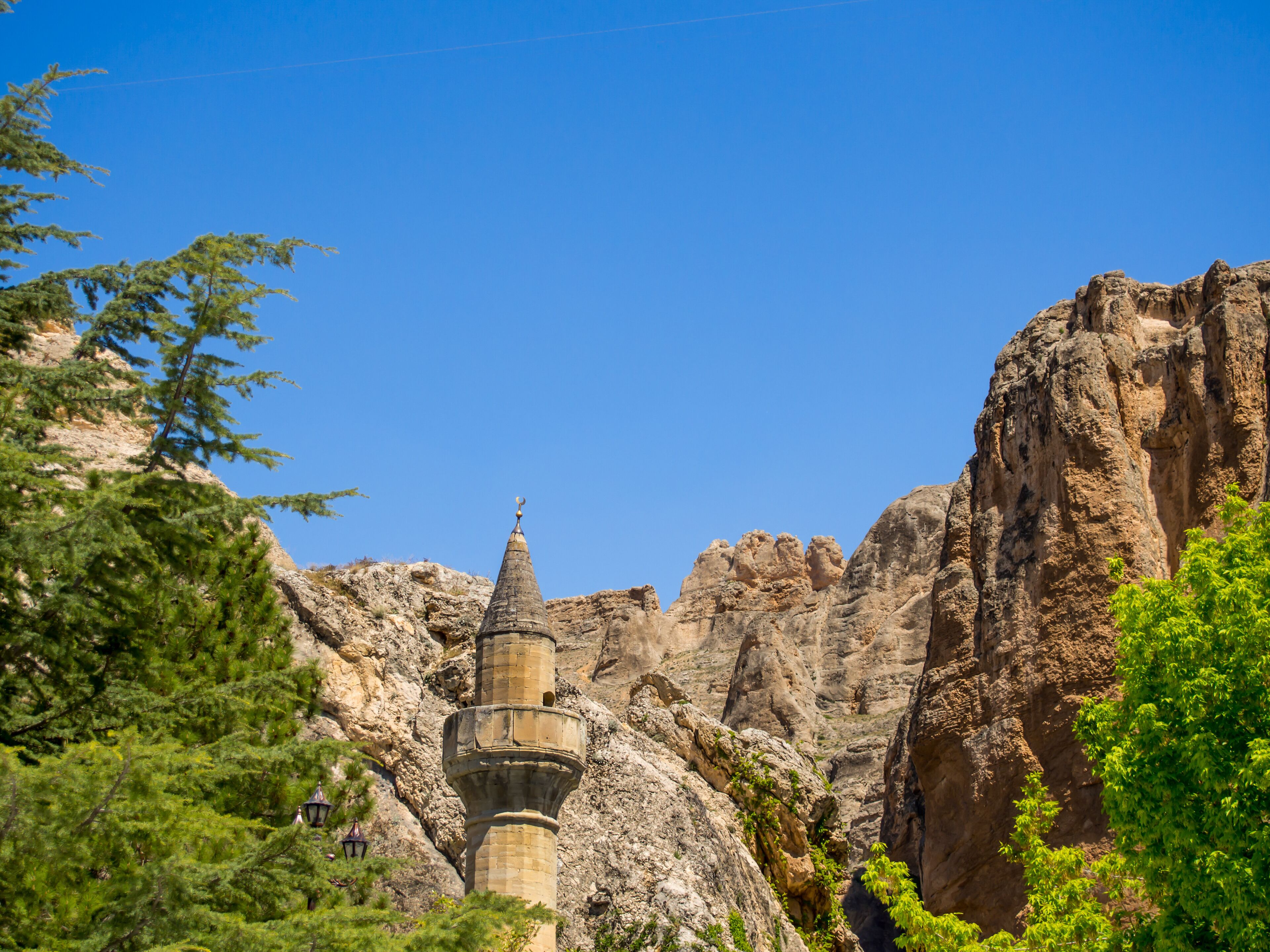 Darende Malatya, Turkey Somuncu father's tomb. Minaret, trees and blue sky.