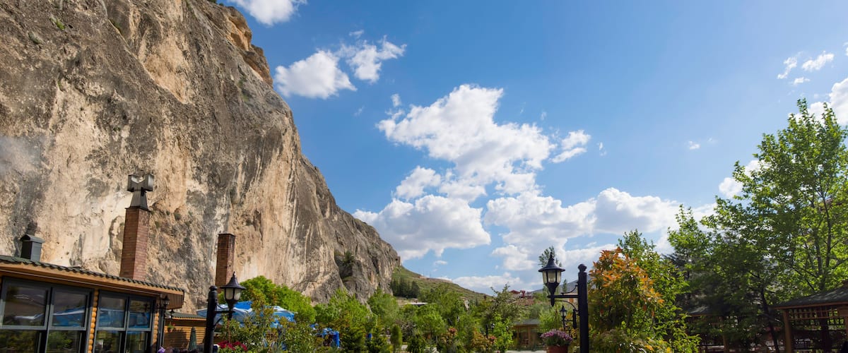A mountainous landscape with a clear sky and a few clouds.