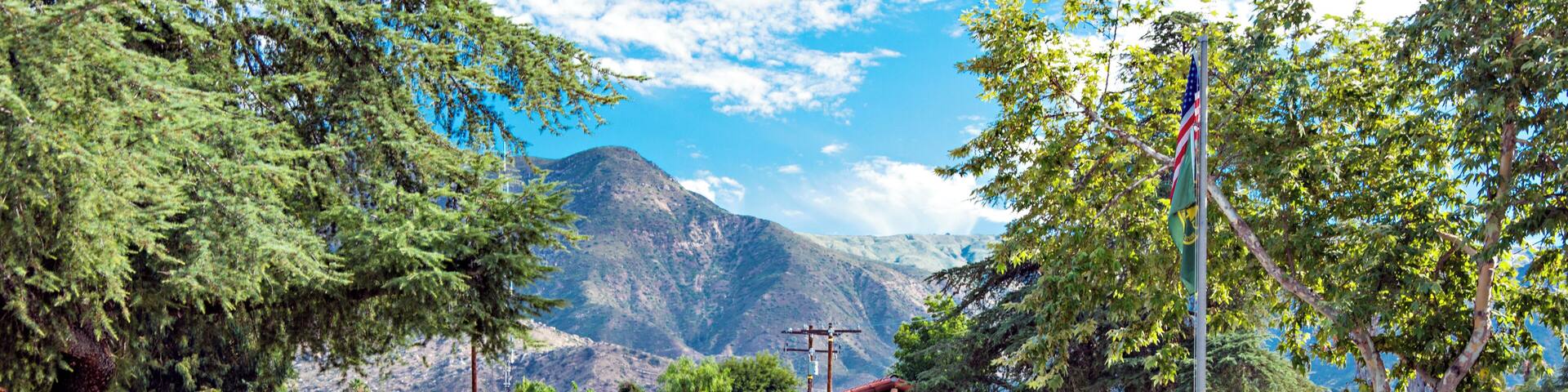 A ranger station with a mountain in the background.