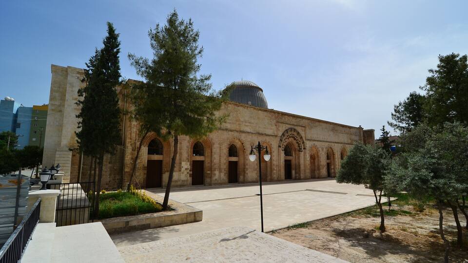 A historic building with arched doorways and a dome.