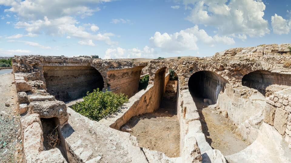 Ancient stone structures with multiple arched passageways.
