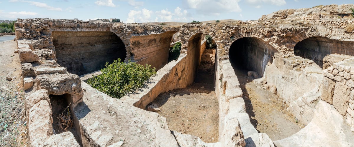 Ancient stone structures with multiple arched passageways.