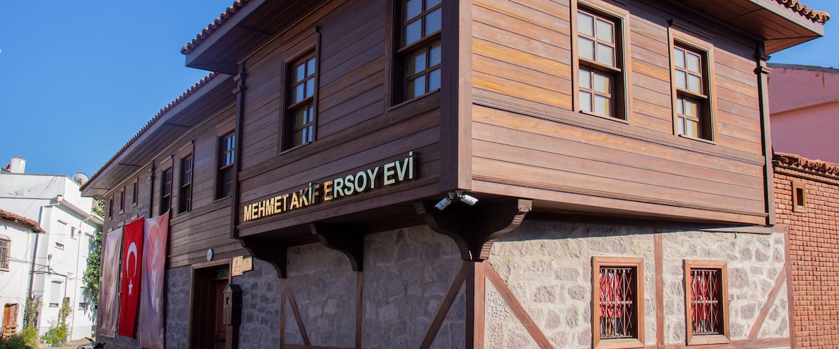 A wooden building with a stone facade and a tiled roof.