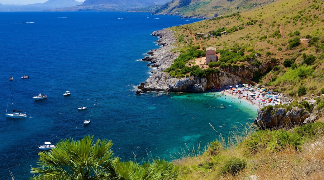 Zingaro Beach featuring landscape views, rugged coastline and a bay or harbor