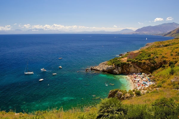 Zingaro Beach showing landscape views, a bay or harbor and rugged coastline