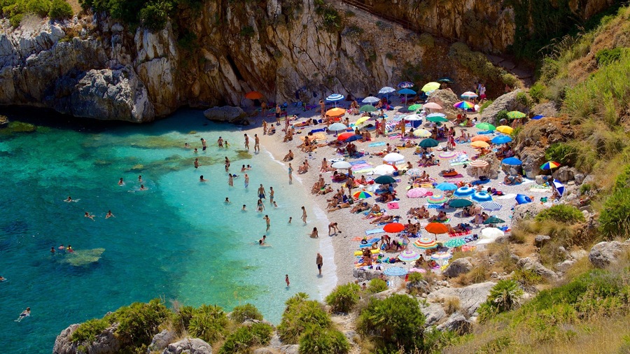 Zingaro Beach featuring a beach, a bay or harbour and swimming