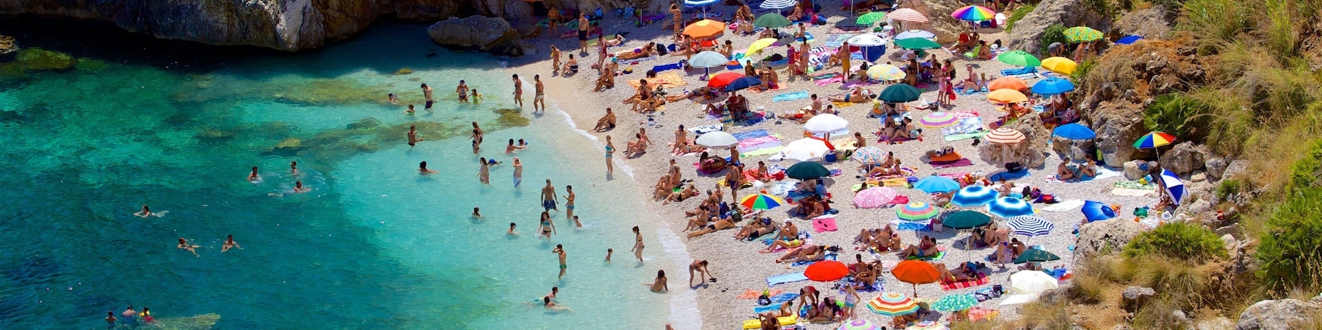 Zingaro Beach featuring swimming, a beach and a bay or harbor