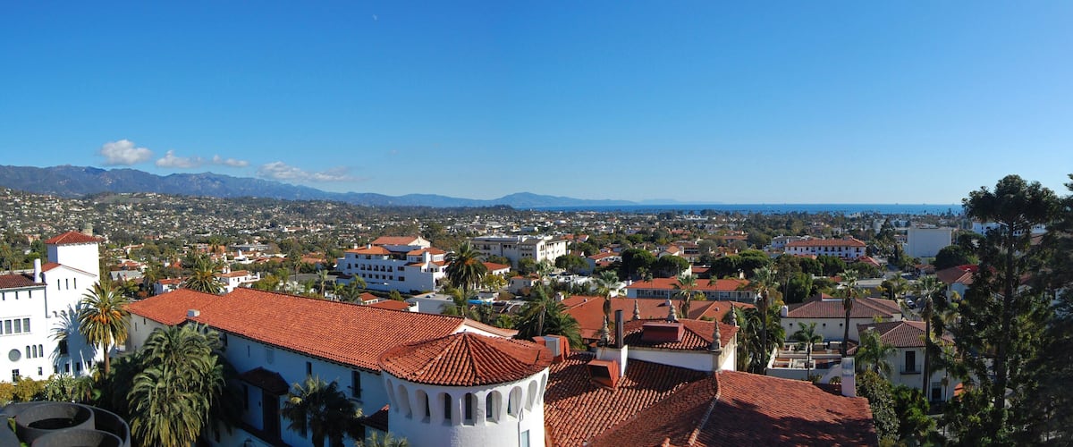Aerial view of Santa Barbara historic city center with Santa Ynez Mountains at the background, from top of the clock tower of Santa Barbara County Courthouse, California CA, USA.