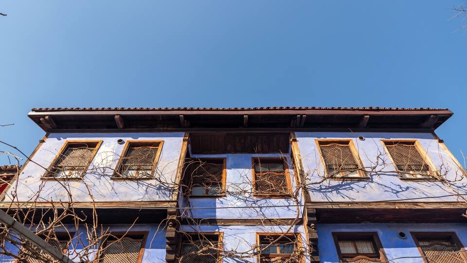 A traditional building with multiple windows and a tiled roof.