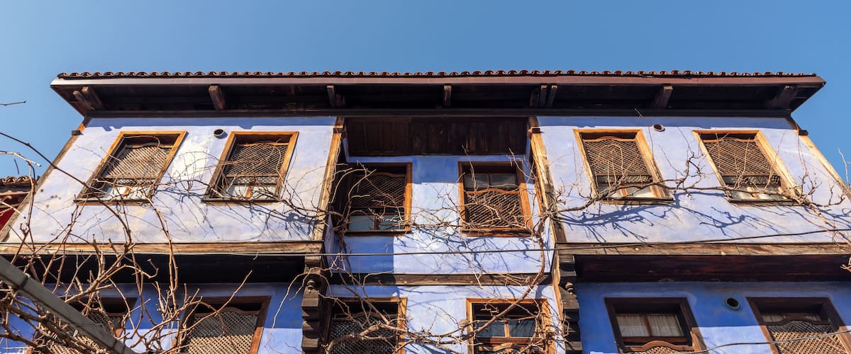 A traditional building with multiple windows and a tiled roof.