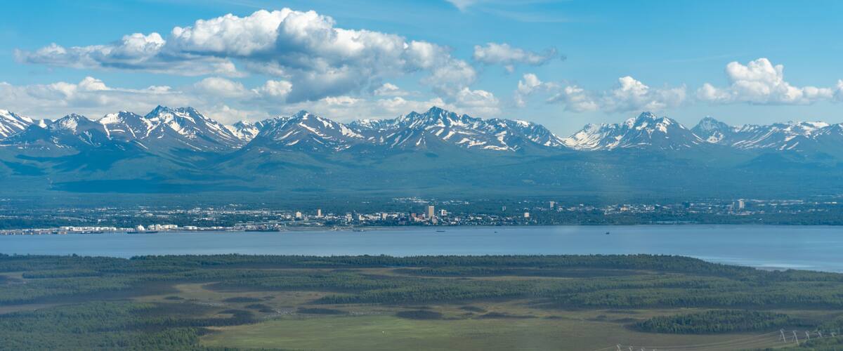 A cityscape with mountains in the background.
