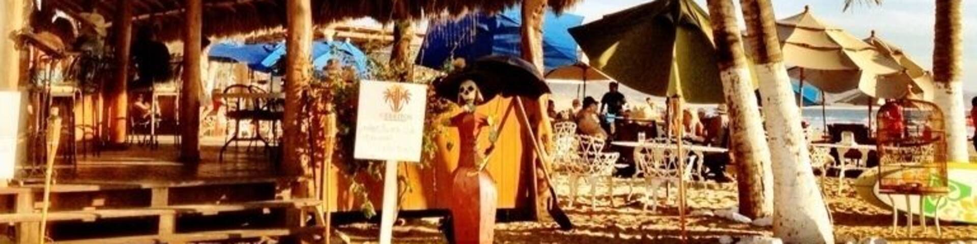 Thatched roof bar 50 yards from a nice surf break. Pretty much in the middle of nowhere on the Pacific Coast of Baja Peninsula. Enjoy the cold beer and singer, but be careful of the food if your digestive antibodies aren't Mexico-strength.