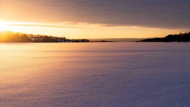 Arctic sunrise over the frozen landscape covered with snow in winter, Harads, Lapland, Sweden, Scandinavia