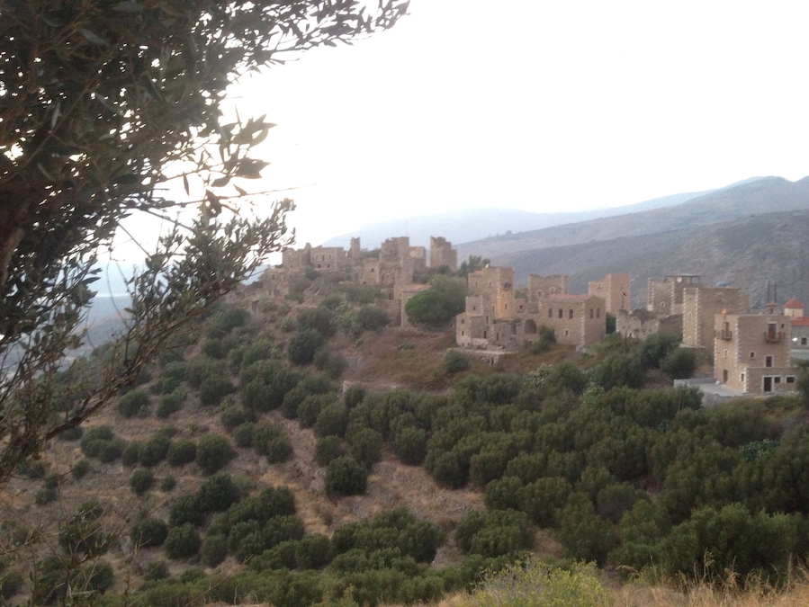An abandoned village is being restored . Towers are being renovated and the journey back in time begins in mani , in Peloponnese, Greece