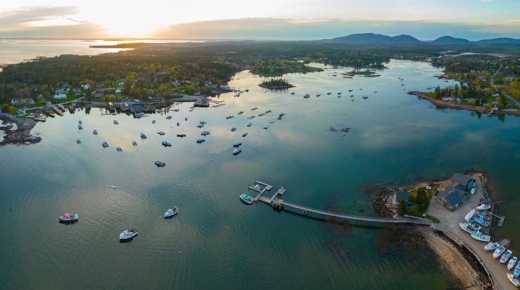 Bass Harbor and village aerial view at sunset with Mountains in Acadia National Park at the background in town of Tremont on Mt Desert Island, Maine ME, USA.