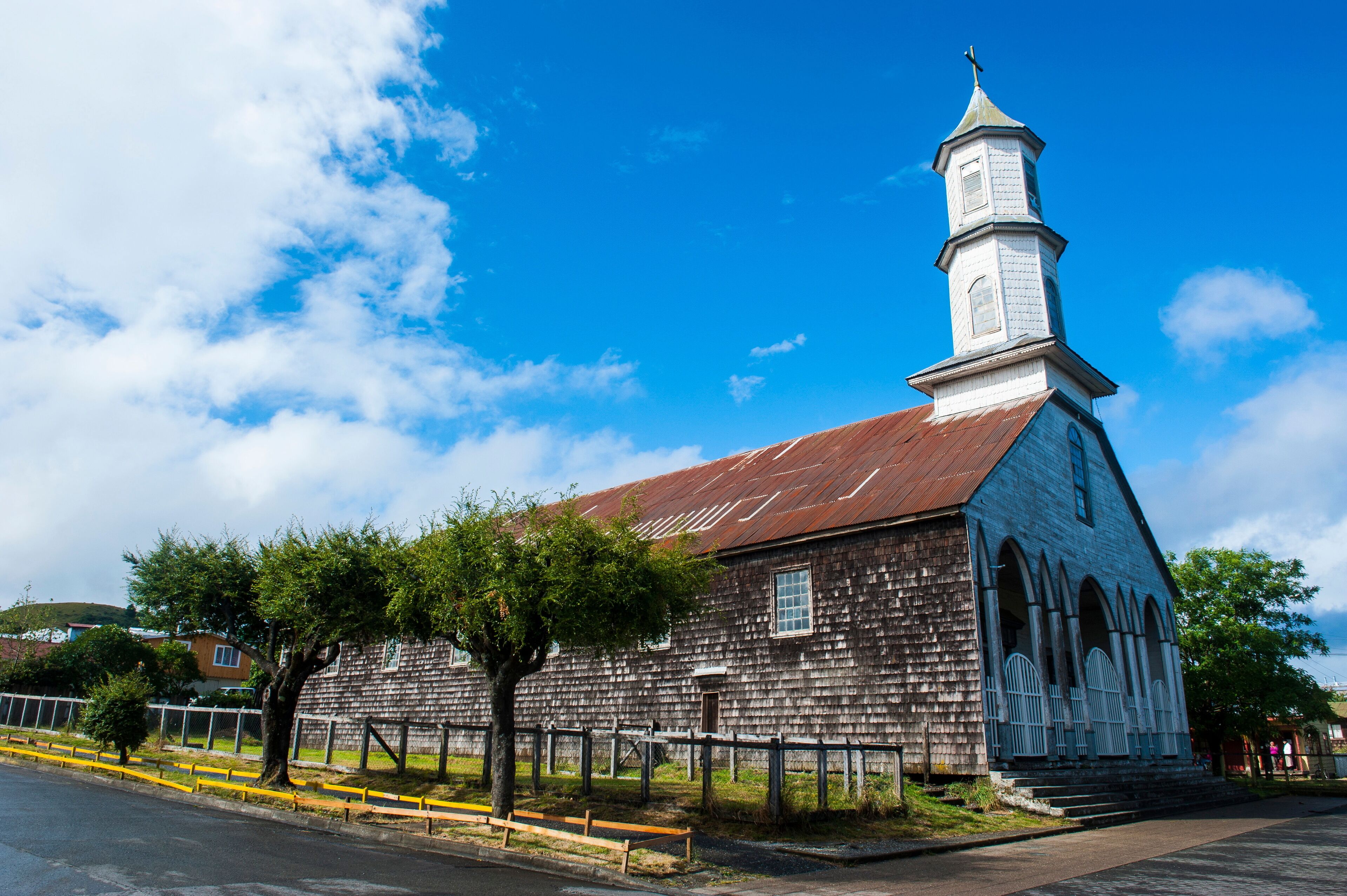 A historic church with a tall steeple and arched windows.