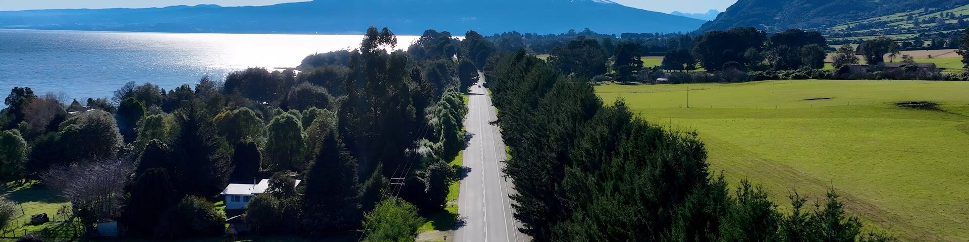 Patagonia Road In Puerto Octay Los Lagos Chile. Highway Interchange Crossing City With Traffic Jam. Nature Travel Destinations Snow Covered Forest Trees. Exploration Snow Covered Aerial.