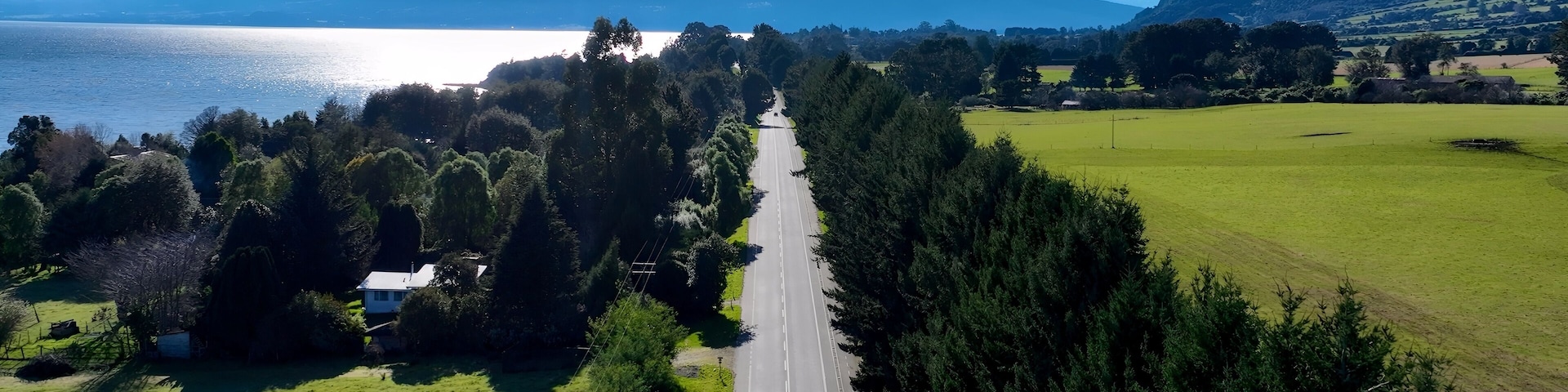 Patagonia Road In Puerto Octay Los Lagos Chile. Highway Interchange Crossing City With Traffic Jam. Nature Travel Destinations Snow Covered Forest Trees. Exploration Snow Covered Aerial.