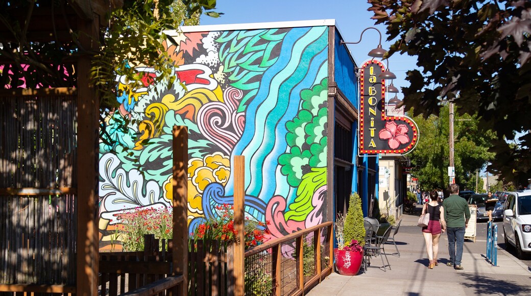 Alberta Street featuring street scenes and outdoor art as well as a couple