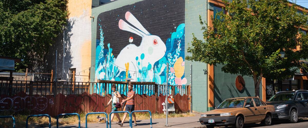 Alberta Street featuring street scenes and outdoor art as well as a couple