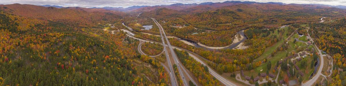Interstate Highway 93 at Exit 30 with US Route 3 and Pemigewasset River in White Mountain National Forest panorama aerial view with fall foliage, Town of Thornton, New Hampshire NH, USA.