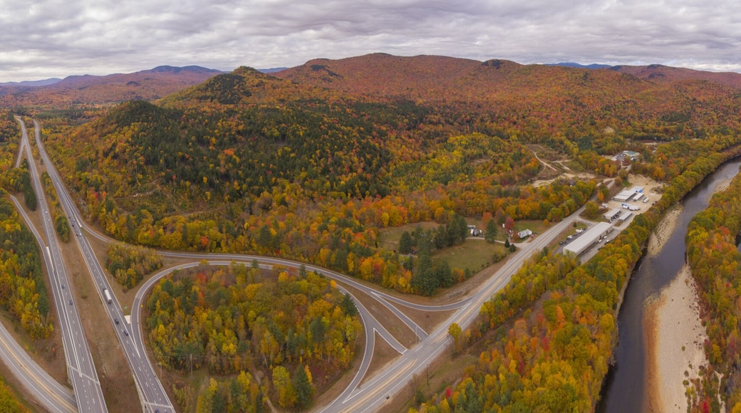 Interstate Highway 93 at Exit 30 with US Route 3 and Pemigewasset River in White Mountain National Forest panorama aerial view with fall foliage, Town of Thornton, New Hampshire NH, USA.