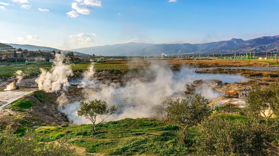 cenic views of thermal springs and mud bath in Sarayköy which contains bicarbonates and sulfates and power plant producing electricity from the geothermal steam, Denizli, Turkey