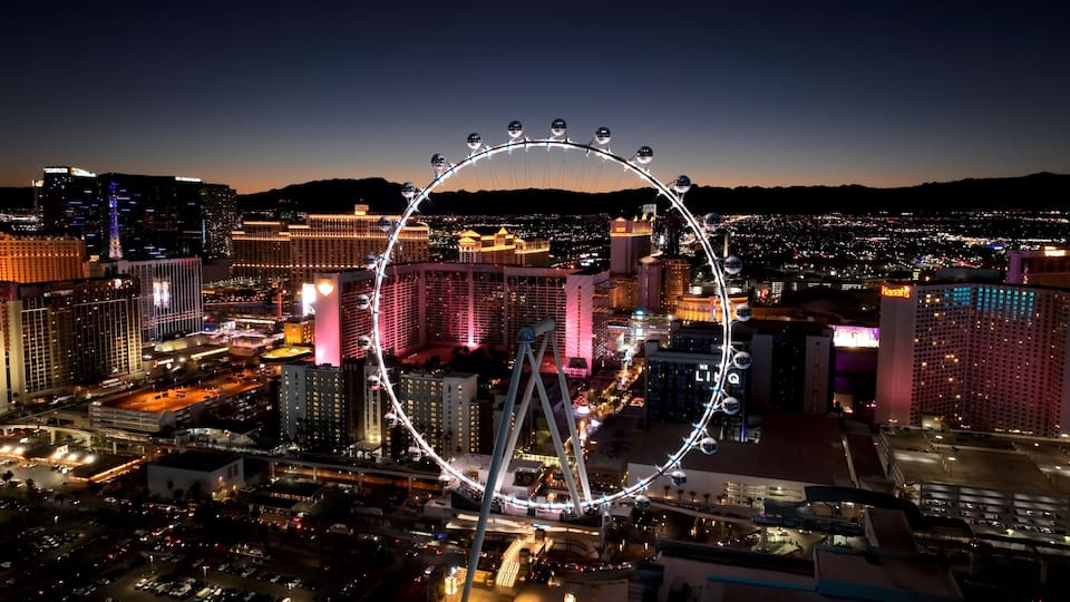 Ferris Wheel In Las Vegas Nevada United States. Las Vegas Skyline Showing Modern Architecture And Festive Scene. Building Industry Skyline Birds View Vibrant. Sunset. Las Vegas Nevada.