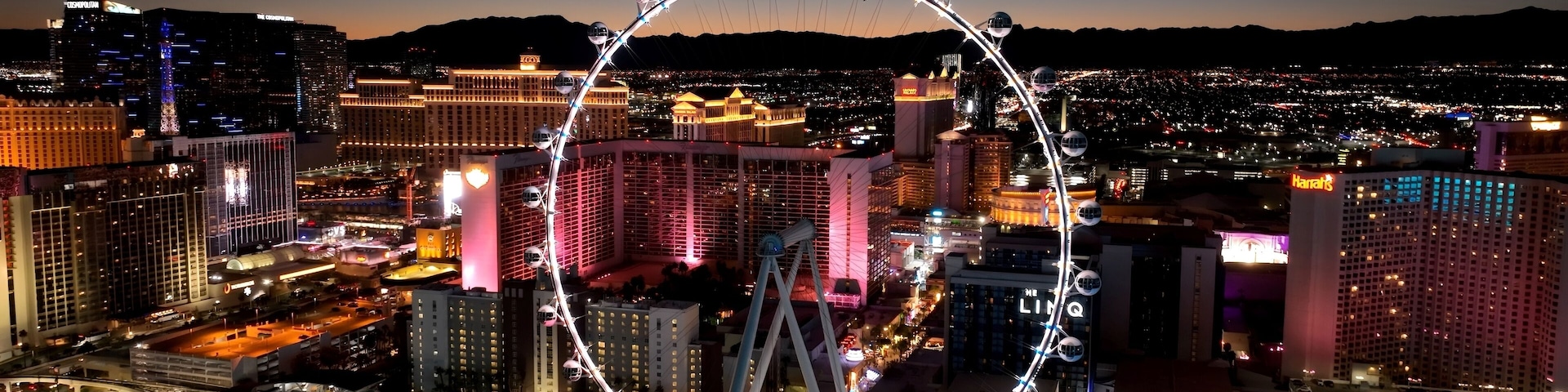 Ferris Wheel In Las Vegas Nevada United States. Las Vegas Skyline Showing Modern Architecture And Festive Scene. Building Industry Skyline Birds View Vibrant. Sunset. Las Vegas Nevada.