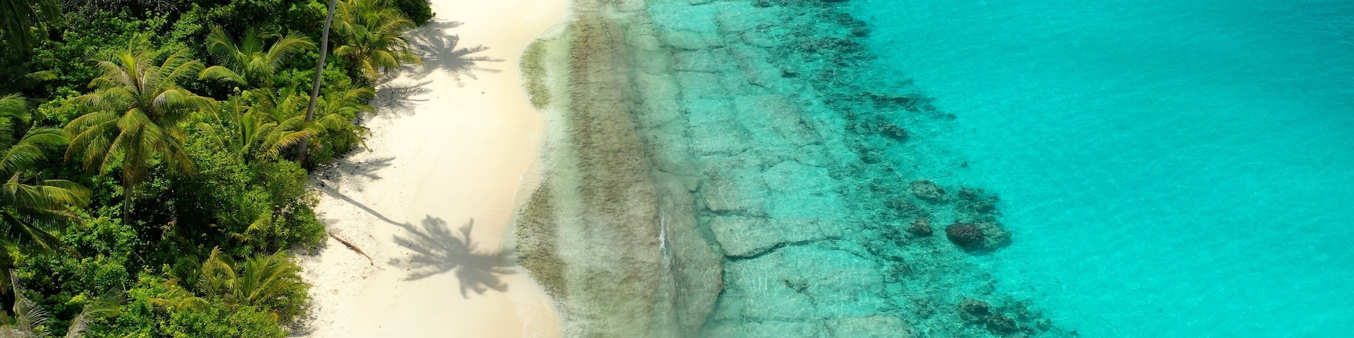 Bird's eye view of tropical islands in the ocean. View of the islands from a drone. Maldives, Thinadhoo (Vaavu Atoll), Dhigurah