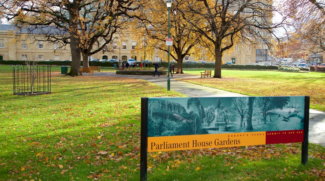 Parliament House featuring a garden, signage and fall colors