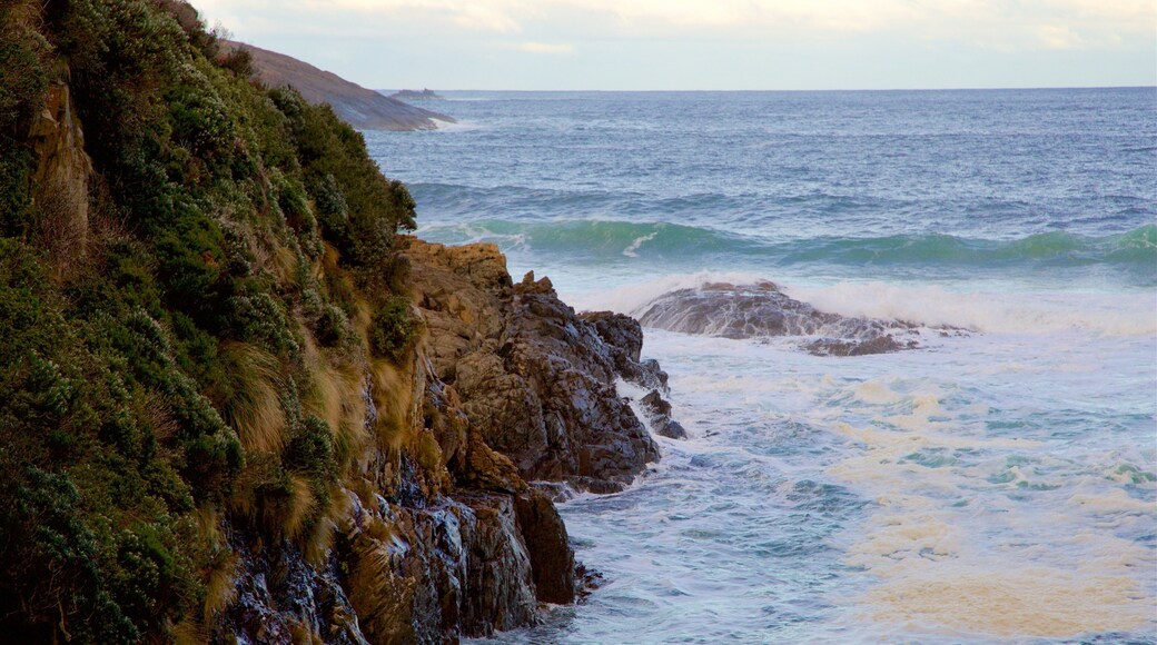 Remarkable Cave featuring waves and rocky coastline
