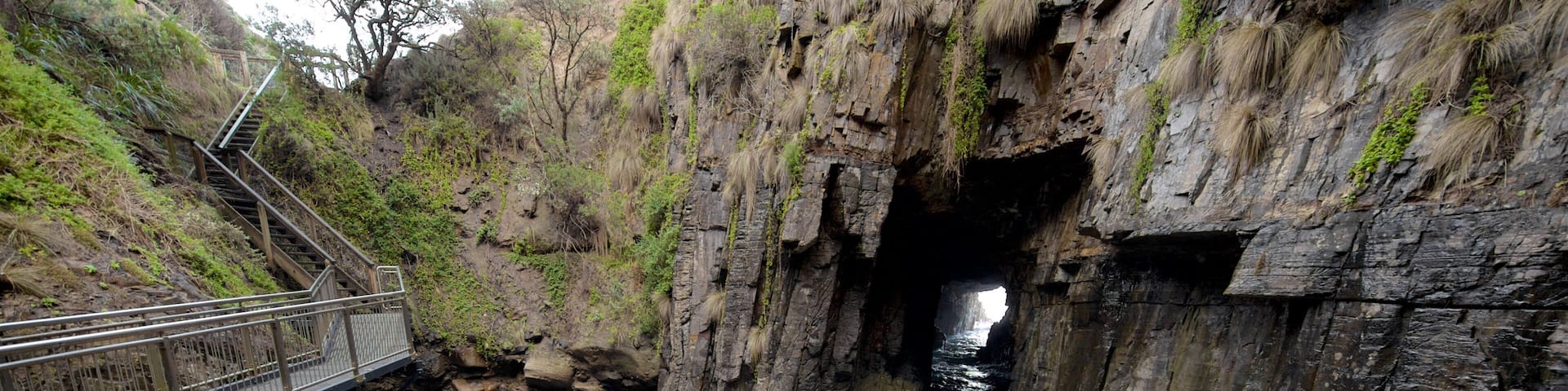 Remarkable Cave showing a sandy beach, caves and rugged coastline