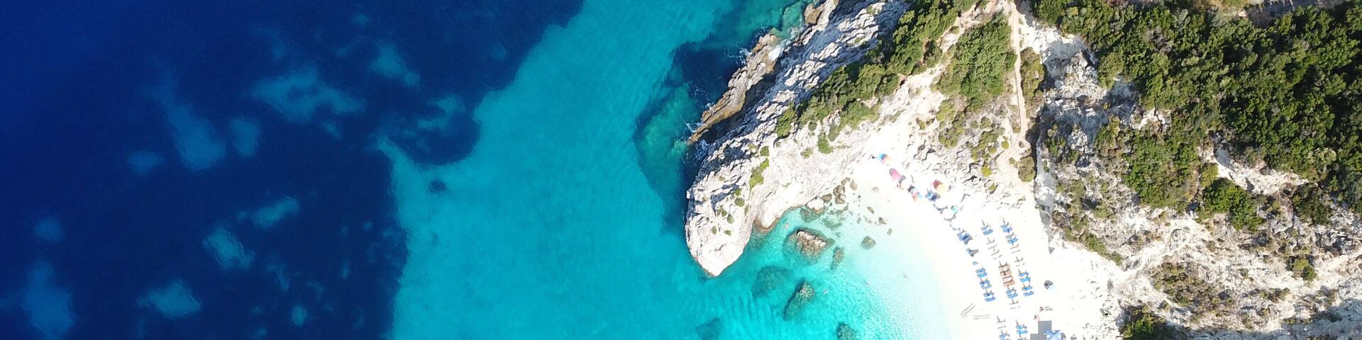 Aerial drone photo of iconic paradise sandy beach of Agiofili near port of Vasiliki with emerald crystal clear sea and sail boats docked, Lefkada island, Ionian, Greece