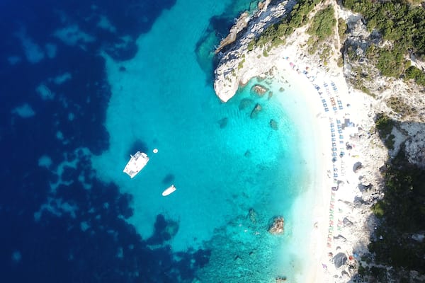 Aerial drone photo of iconic paradise sandy beach of Agiofili near port of Vasiliki with emerald crystal clear sea and sail boats docked, Lefkada island, Ionian, Greece