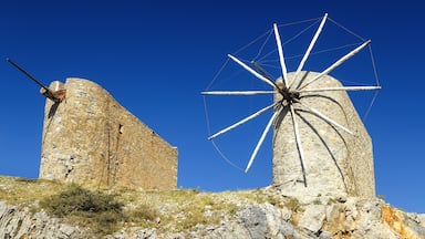 Traditional old windmill on the island Crete, Greece. Beautiful landscape with blue sky